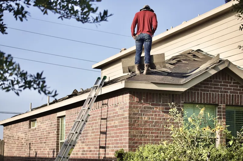 Professional roofer working on a residential roof in Apex